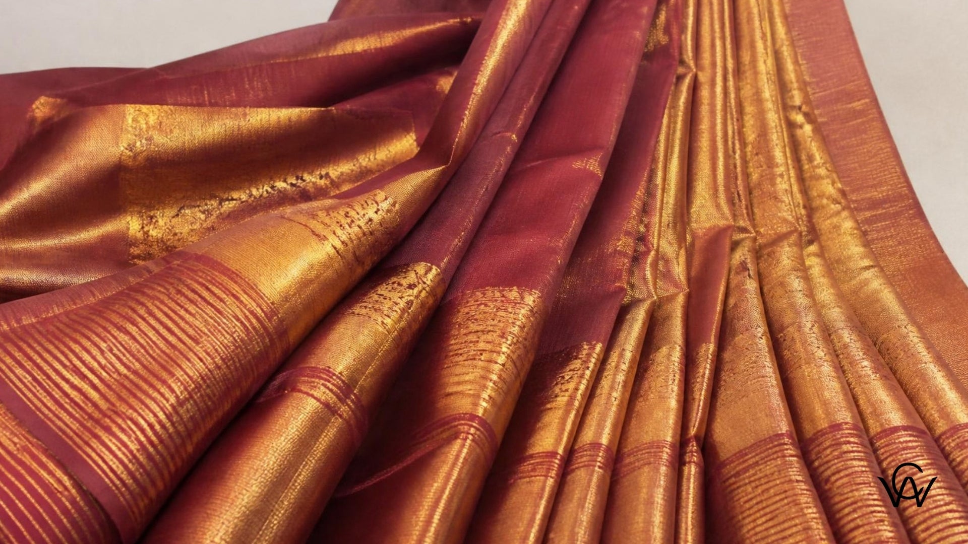 Silk saree fabric draped with rich texture and gold border - Clothwala fabric photography