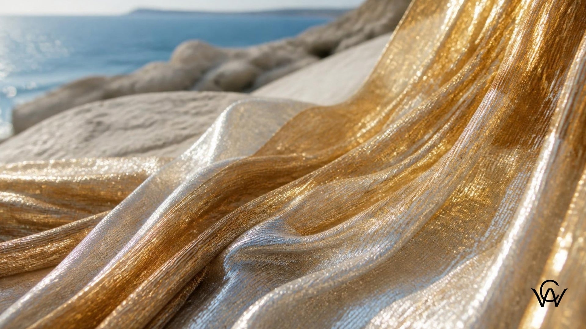 Shimmering gold and silver lurex fabric draped and catching bright summer sunlight at Clothwala