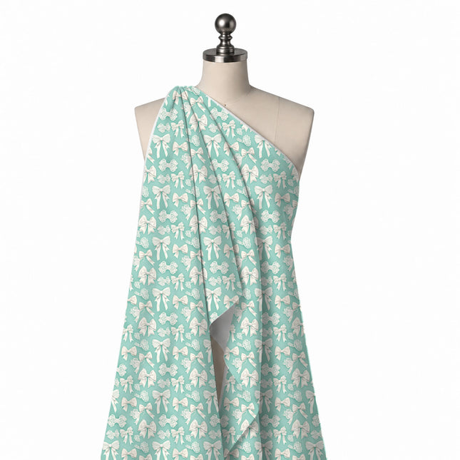 Draped on a mannequin: close-set all-over print of small to medium white and ivory bows, design Design No_4438, Clothwala