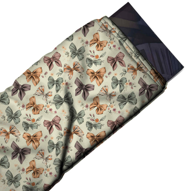 Flat fabric swatch: dense tossed layout of small outlined bows in mustard orange, design Design No_4407, Clothwala