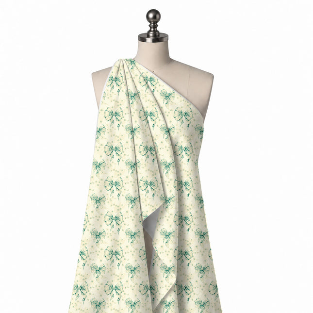 Draped on a mannequin: half-drop repeat of large watercolour-style sea green bows, design Design No_4454, Clothwala
