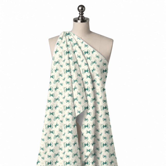 Draped on a mannequin: tossed layout of small to medium teal green bows with engraved line, design Design No_4443, Clothwala