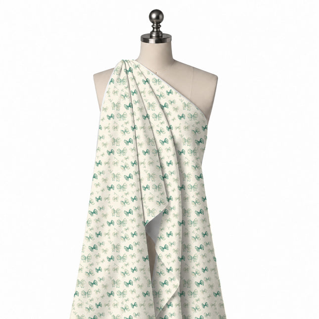 Draped on a mannequin: scattered layout mixing small solid teal green bows with larger, design Design No_4450, Clothwala
