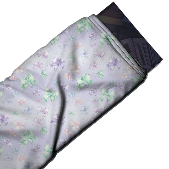 Flat fabric swatch: scattered small to medium bows in mint green, violet, design Design No_4417, Clothwala