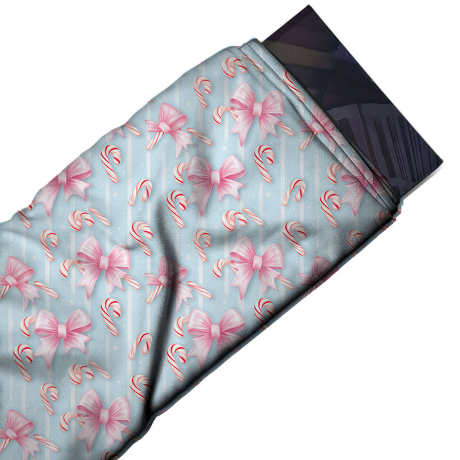 Flat fabric swatch: all-over layout of shaded pink ribbon bows with notched tails and, design Design No_4879, Clothwala