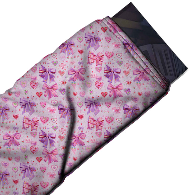 Flat fabric swatch: busy small-scale layout of glossy purple and pink satin bows, design Design No_4465, Clothwala