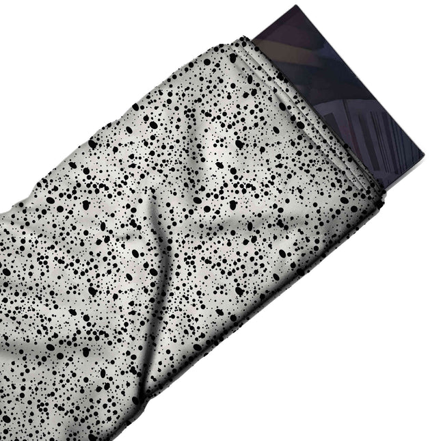 Flat fabric swatch: dense all-over speckle of tiny black dots and small irregular blots in, design Design No_4034, Clothwala