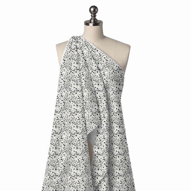 Draped on a mannequin: dense all-over speckle of tiny black dots and small irregular blots, design Design No_4034, Clothwala