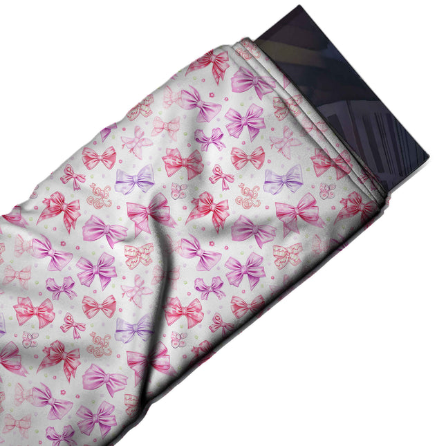 Flat fabric swatch: tossed layout of small to medium watercolour-style bows in hot pink, design Design No_4467, Clothwala
