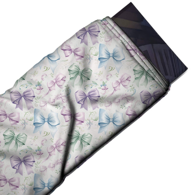 Flat fabric swatch: all-over layout of medium softly shaded bows in mint green, lilac, design Design No_4415, Clothwala