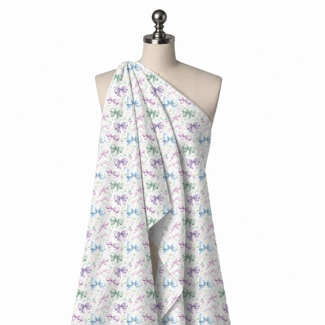 Draped on a mannequin: all-over layout of medium softly shaded bows in mint green, lilac, design Design No_4415, Clothwala
