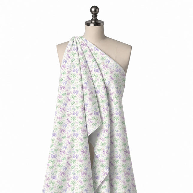 Draped on a mannequin: busy tossed layout of small outlined bows in mint green, lilac, design Design No_4416, Clothwala