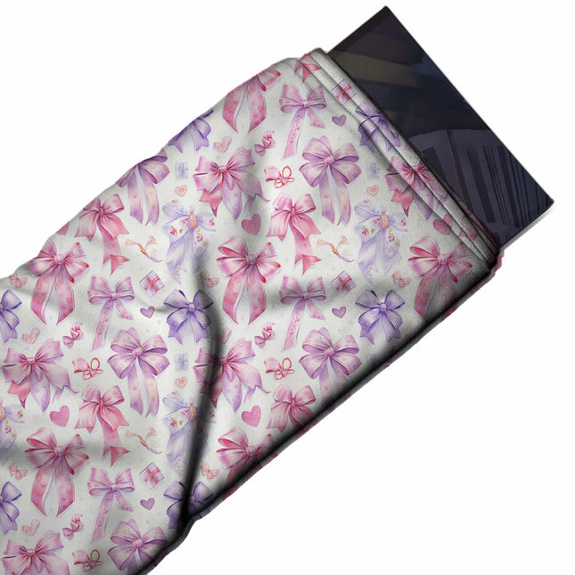 Flat fabric swatch: dense all-over layout of medium watercolour-style satin bows with, design Design No_4458, Clothwala