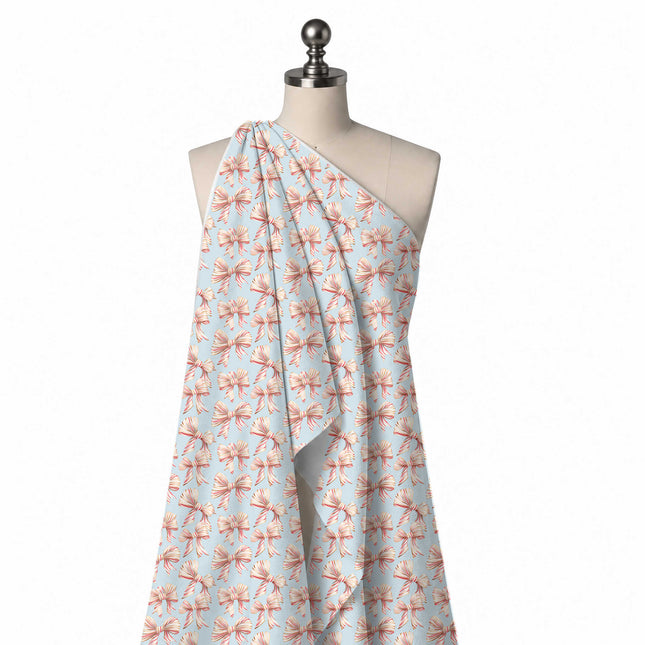 Draped on a mannequin: regular all-over layout of shaded cream ribbon bows with fine red, design Design No_4881, Clothwala