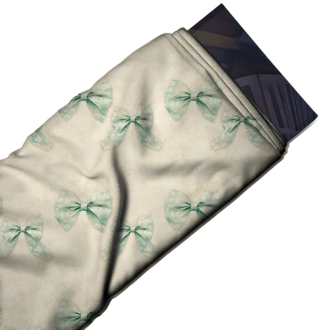 Flat fabric swatch: widely spaced repeat of paired mint green bows with a white lace-like, design Design No_4436, Clothwala