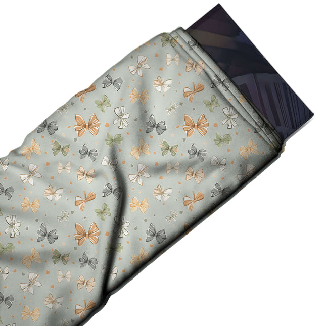 Flat fabric swatch: small-scale tossed layout of sketched ribbon bows in orange, peach, design Design No_4394, Clothwala