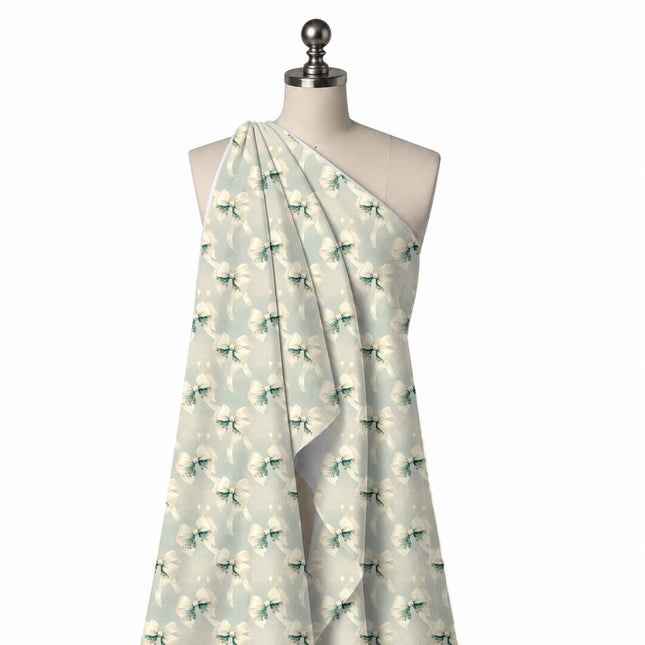 Draped on a mannequin: half-drop repeat of large soft-shaded ivory satin bows with teal, design Design No_4441, Clothwala