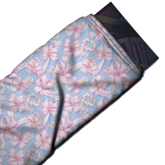 Flat fabric swatch: dense tossed layout of pale pink satin ribbon bows with trailing, design Design No_4868, Clothwala