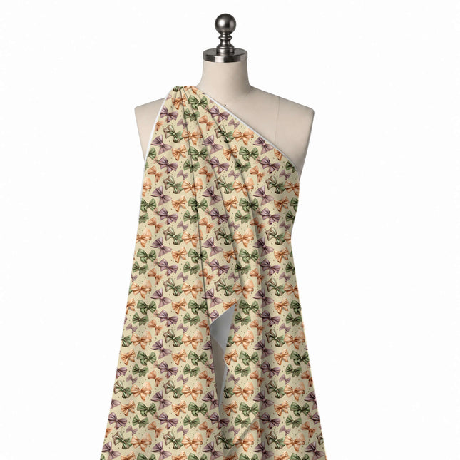 Draped on a mannequin: dense tossed layout of medium shaded bows in green, design Design No_4402, Clothwala