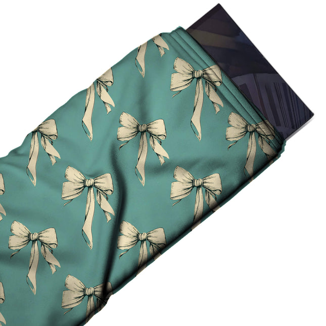 Flat fabric swatch: half-drop repeat of medium cream bows with long hanging tails, design Design No_4444, Clothwala