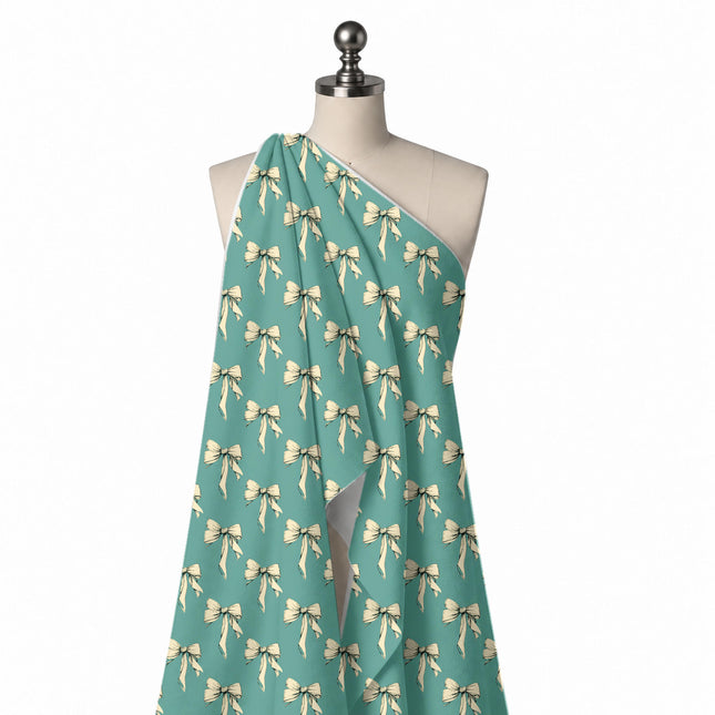 Draped on a mannequin: half-drop repeat of medium cream bows with long hanging tails, design Design No_4444, Clothwala