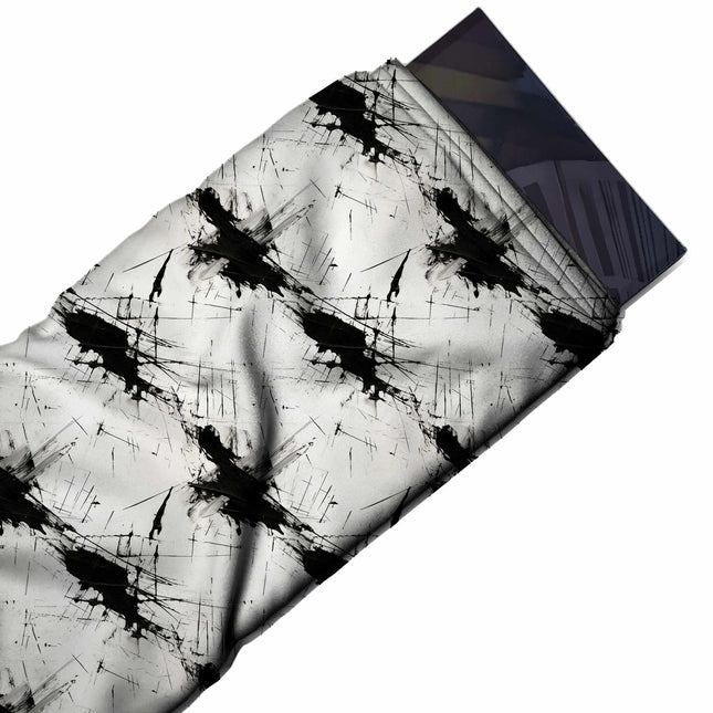 Flat fabric swatch: spaced repeat of large black ink splatters running on a diagonal, design Design No_3994, Clothwala