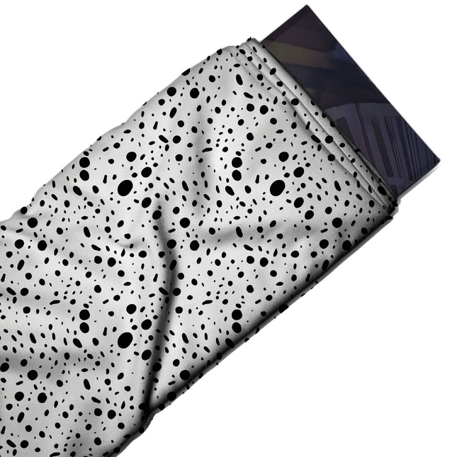 Flat fabric swatch: all-over scatter of flat black oval dots and short elongated dashes in, design Design No_4032, Clothwala