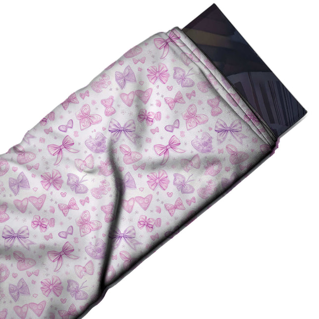 Flat fabric swatch: tossed small-scale layout of pink and lilac bows in varied styles with, design Design No_4457, Clothwala