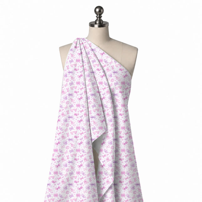 Draped on a mannequin: tossed small-scale layout of pink and lilac bows in varied styles, design Design No_4457, Clothwala