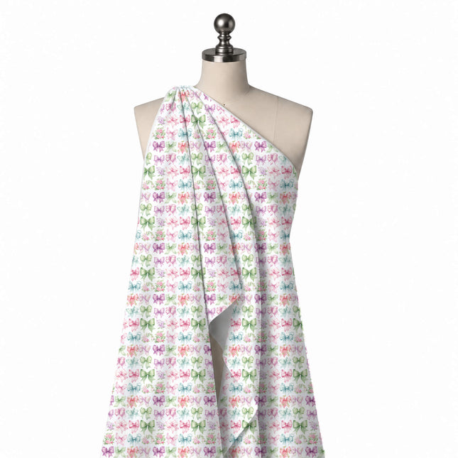 Draped on a mannequin: grid-like rows of small watercolour bows in pink, green, lilac, design Design No_4421, Clothwala
