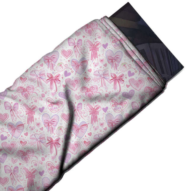 Flat fabric swatch: dense all-over layout of pink and lilac hearts, some topped with bows, design Design No_4466, Clothwala