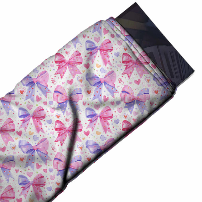 Flat fabric swatch: all-over layout of large bows split between pink and periwinkle with, design Design No_4473, Clothwala
