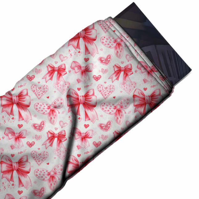 Flat fabric swatch: all-over layout of large watercolour-style red bows and paler pink, design Design No_4461, Clothwala